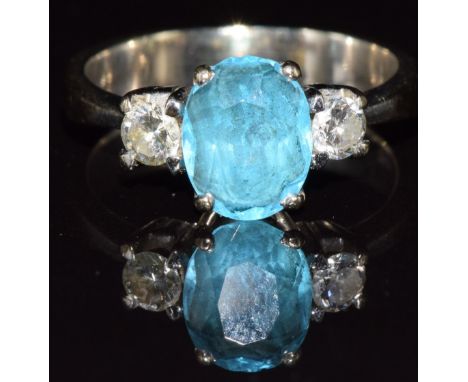 An 18k white gold ring set with an oval cut topaz and two diamonds, each approximately 0.15ct each, 5.2g, size M