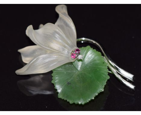 A 14k white gold brooch in the form of a lily set with nephrite jade, quartz, rubies and a diamond, 13.8g, 4.8cm