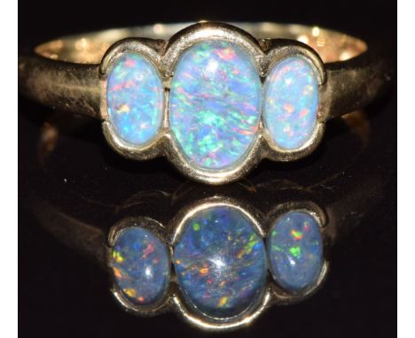 A 9k gold ring set with three opal triplets, 2.3g, size N