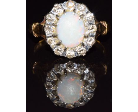 An 18ct gold ring set with an opal and diamonds, 5.5g, size O/P