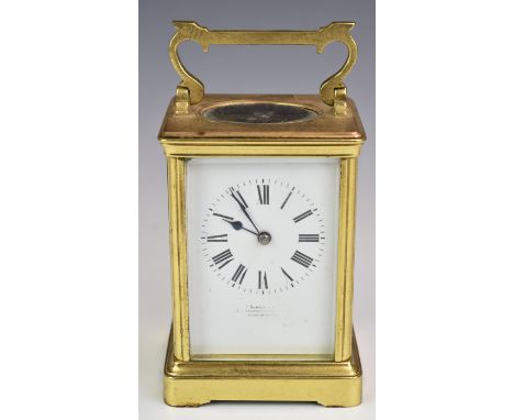 Brass cased carriage clock, with white enamel dial, visible balance wheel to top and striking on a gong, height including han