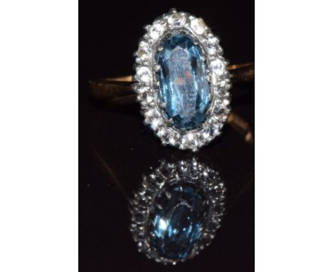 An 18k gold ring set with a topaz and white sapphires, 2.4g, size M