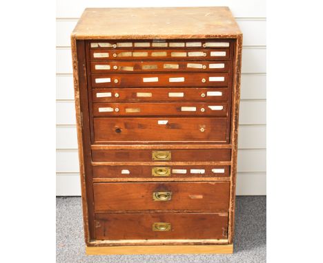 Victorian pine campaign chest of 11 graduated drawers with panelled front door, containing a plethora of watch / clock making