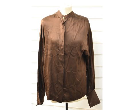 Vintage blouse with Chanel label and button to the collar. Consigned by a former employee of Chanel