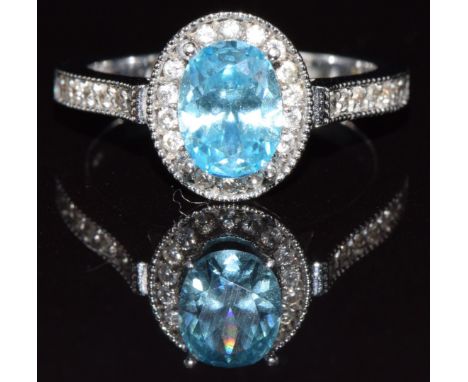 An 18k white gold ring set with an oval cut treated quartz and diamonds, 4.9g, size M