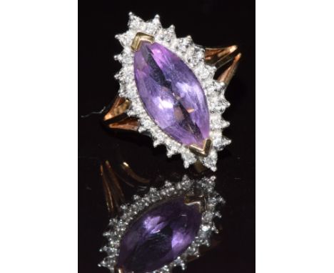 A 9ct gold ring set with a marquise cut amethyst surrounded by diamonds, 3.2g, size K