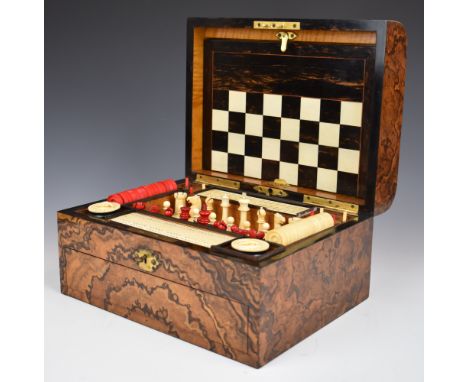 Late 19thC walnut cased games compendium, the domed lid opening to reveal a fitted satinwood interior with a folding ebony an