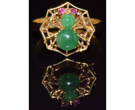 An 18k gold ring in the form of a spider and web set with jadeite cabochons and ruby eyes, 3.1g, size L/M&nbsp;