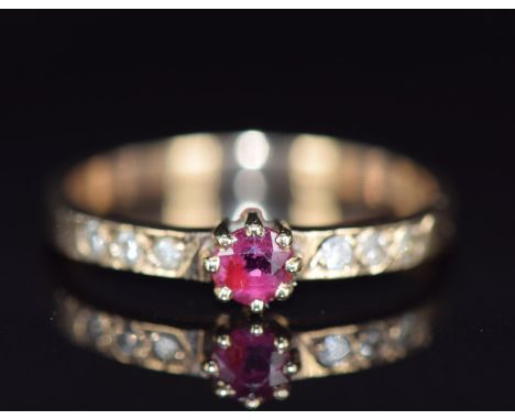 A 9ct gold ring set with a ruby and diamonds, 1.5g, size J