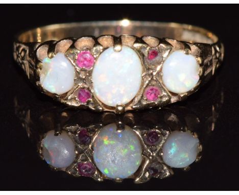 A 9ct gold ring set with opals and rubies, 1.6g, size K