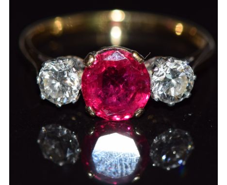 An 18ct gold ring set with an oval cushion cut synthetic ruby approximately 1.6ct and two diamonds each approximately 0.4ct, 
