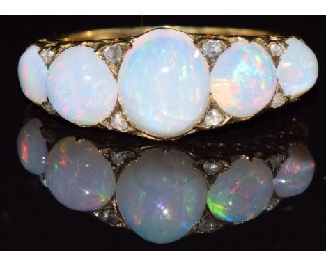 A c1900 18ct gold ring set with five opal cabochons and rose cut diamonds, 4.9g, size O