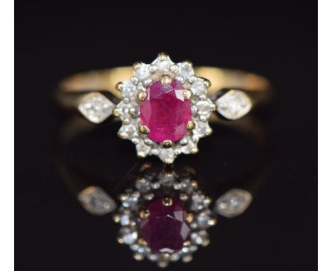 A 9ct gold ring set with a ruby and diamonds, 1.6g, size L