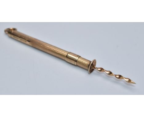 9ct gold toothpick with engine turned decoration, length when extended 8.5cm, weight 4.1g
