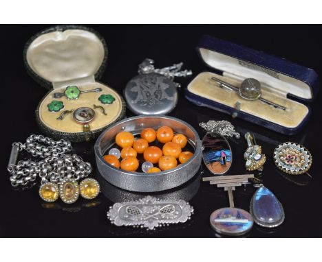 A collection of silver jewellery including Victorian locket, Art Deco butterfly wing pendants, Victorian brooch set with citr