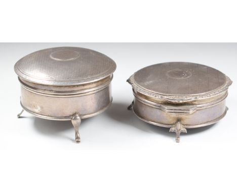 Two hallmarked silver dressing table trinket boxes, both raised on three feet, one Walker &amp; Hall, Birmingham 1916 the oth