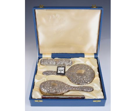 Broadway hallmarked silver dressing table set in original box, comprising hand mirror two brushes and comb, Birmingham 1984, 