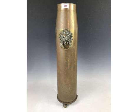 A large brass shell case converted to serve as a stick stand