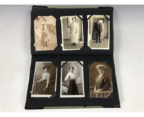 A vintage postcard album together with a quantity of postcards