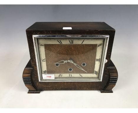 An oak cased mantel clock