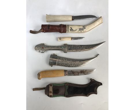 A Swedish hunting knife by Morakniv, a Finish bone-handled hunting knife and one other Middle Eastern dagger