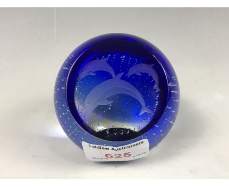 A Caithness glass paperweight, bubble included and wheel-cut in depiction of dolphins