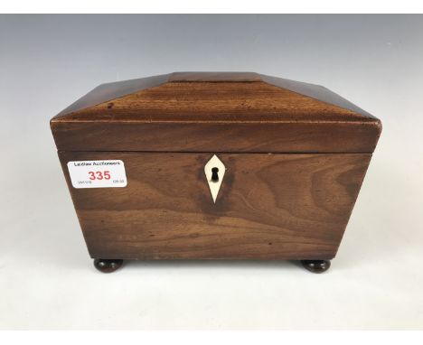 A Georgian mahogany sarcophagus form tea caddy, opening to reveal two covered compartments (later replacements), one compartm