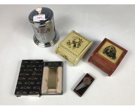 A Colibri lighter together with two mid 20th Century printed tinplate table cigarette boxes, a 1940s tea caddy and pocket kni