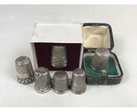 Silver and white-metal thimbles, including one 19th Century silver thimble in a fitted presentation case, and one other 1851 