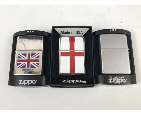 A Union Jack Zippo lighter together with two others