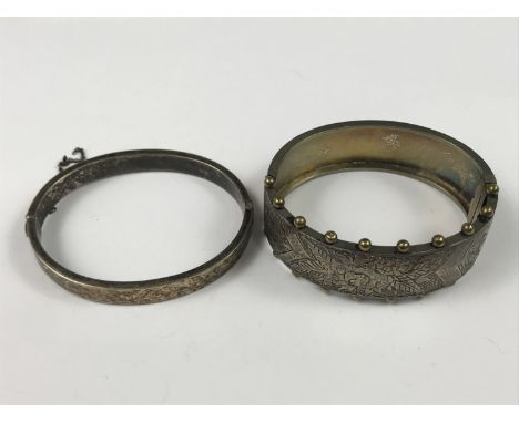 A vintage silver bangle faced with 9ct gold and foliate engraved, 14.6g, together with one other late Victorian hinged bangle