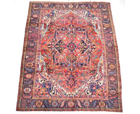 Heriz Ahar Carpet Iranian Azerbaijan, circa 1920 The terracotta field with large flowerhead medallion framed by ivory spandre