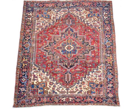 Heriz Carpet of Unusual Size Iranian Azerbaijan, circa 1930 The brick red field of angular vines around a stepped medallion f