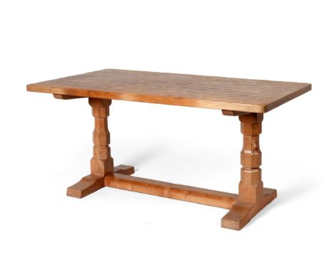 Mouseman: A Robert Thompson English Oak 5ft Refectory Dining Table, the rectangular dowelled top on two carved octagonal legs