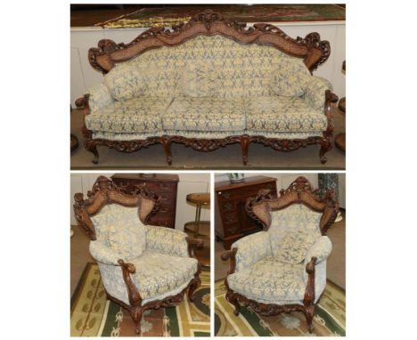 A Late 19th Century Carved Walnut Three Piece Suite, later covered in blue and gold cut velvet, comprising  a three-seater so