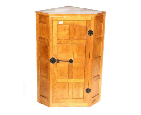 Mouseman: A Robert Thompson Panelled English Oak Hanging Corner Cupboard, wrought-iron hinges and latch, three fixed shelves,