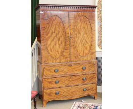 A George III Mahogany and Boxwood Strung Linen Press, circa 1800, with a dentil and arcaded cornice above two oval recessed c