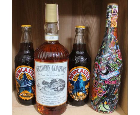 A bottle of "Southern Comfort" 1 litre, a bottle of "Christian Audigier" Rose wine and two bottles Newcastle Brown Ale (4)