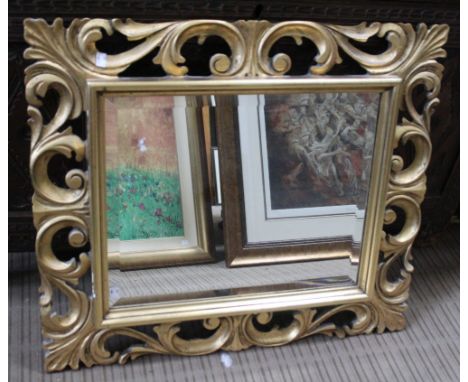 A bevel plate wall mirror with decorative gilt frame