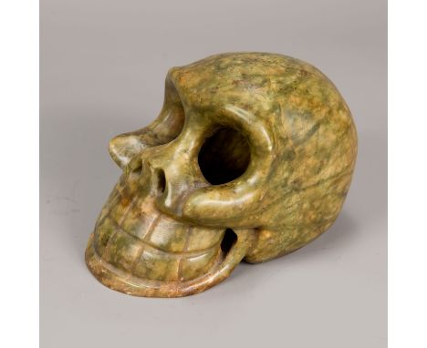 Jade skull, light green colour with white incrustations, open work sculpted; Qing Dynasty. 15X10cm  