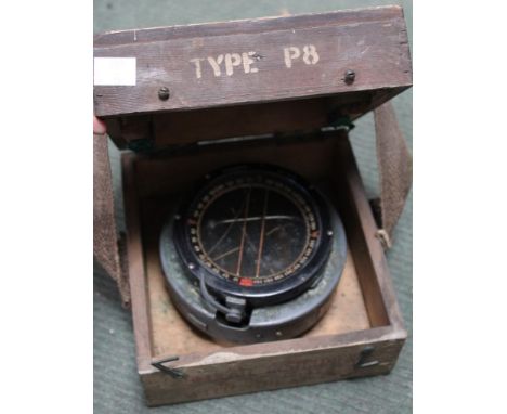 A WWII 1942 compass in original wooden carrying case