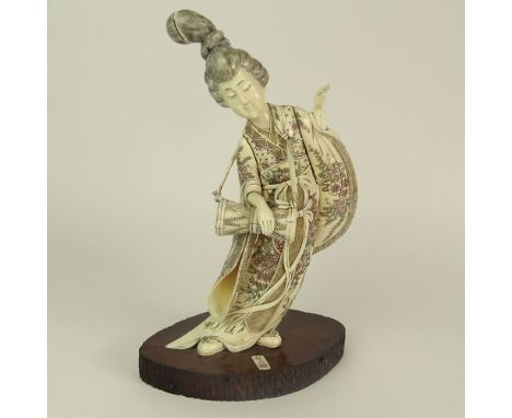 Japanese Carved Ivory Geisha Figure on Carved Wood Base. Signed. Good condition. Measures 13" H, 8" W. This item will only be
