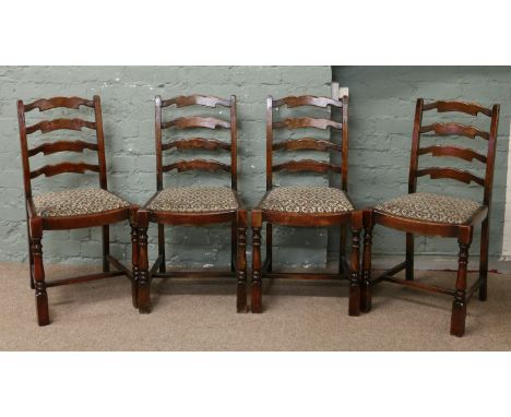 A set of four oak ladder back dining chairs with H stretchers.