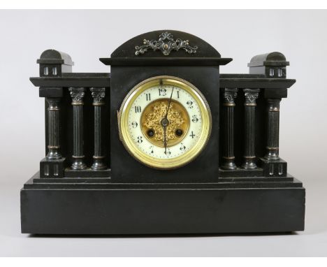 A Victorian slate dome topped mantel clock with enamel chapter ring and with fluted column supports.
