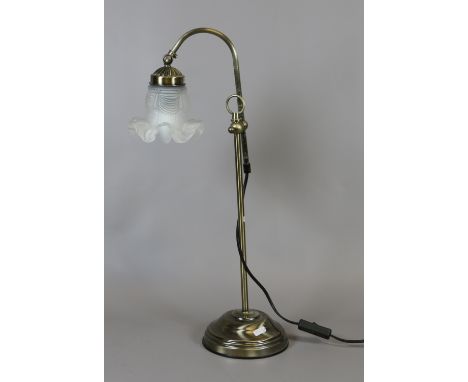 A brass effect adjustable table lamp with clouded shade.