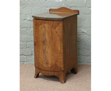 An inlaid mahogany bow front pot cupboard with reeded mouldings and raised on splay bracket supports.