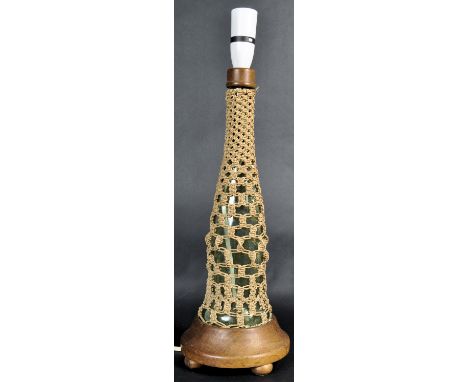 A retro vintage mid 20th Century Cornish glass bottle lamp constructed from a glass bottle wrapped in knotted half hitches ra