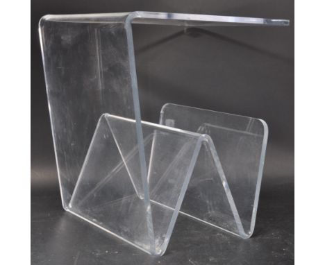 A retro vintage 20th Century transparent acrylic / lucite plastic coffee table of square form having a magazine rack below. M