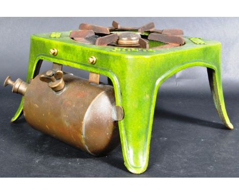 An early 20th Century French cast iron and enamel primus stove. The stove having a central burner within green enamel coated 