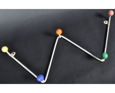 A set of retro vintage mid 20th Century sputnik atomic coat hooks and magazine rack of 'W' shape form with painted multi colo
